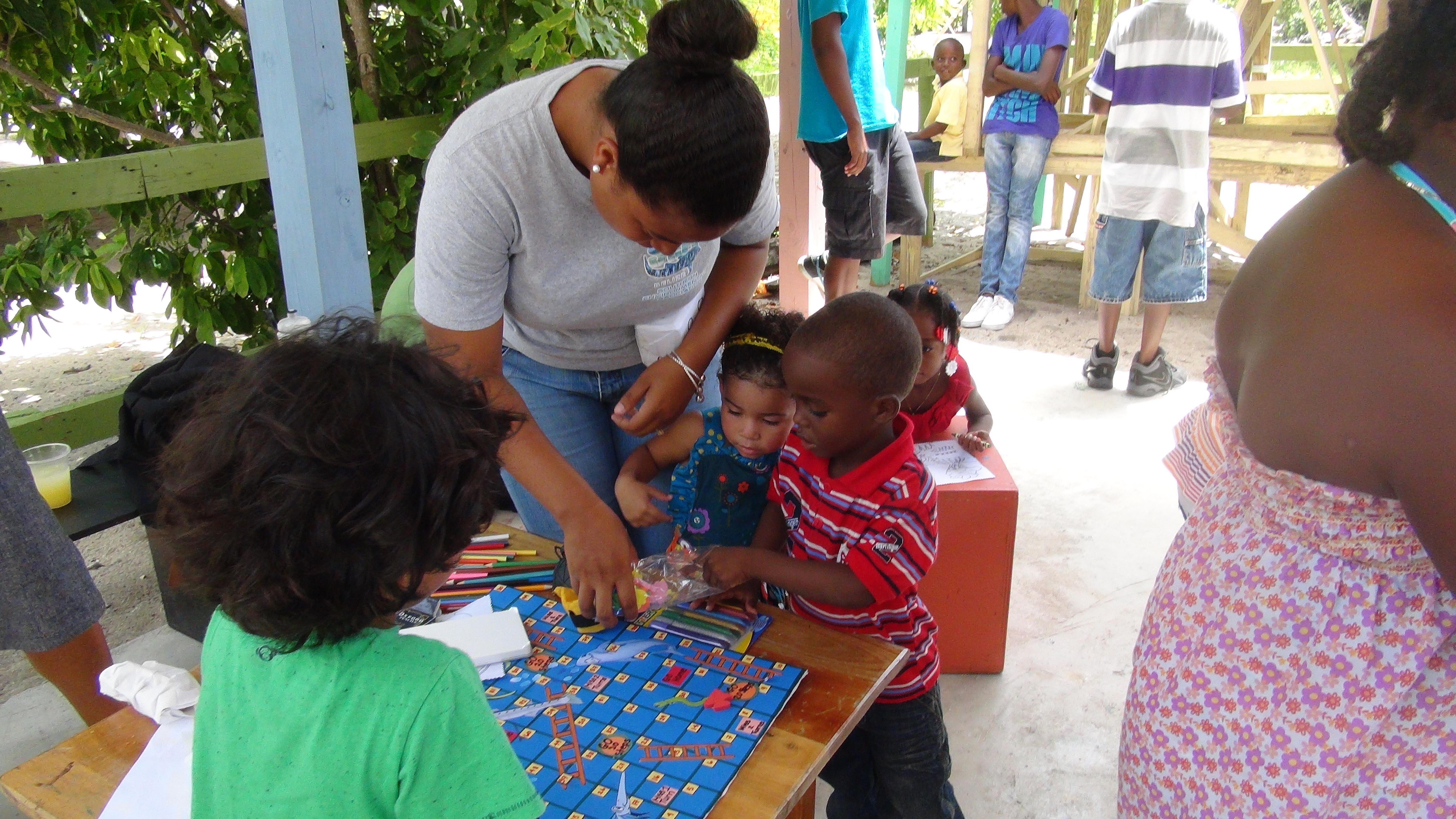 A high school student works with children and helps with marine conservation work in Belize A Projects Abroad volunteer does conservation work and teaches children in Belize on our project for teenagers